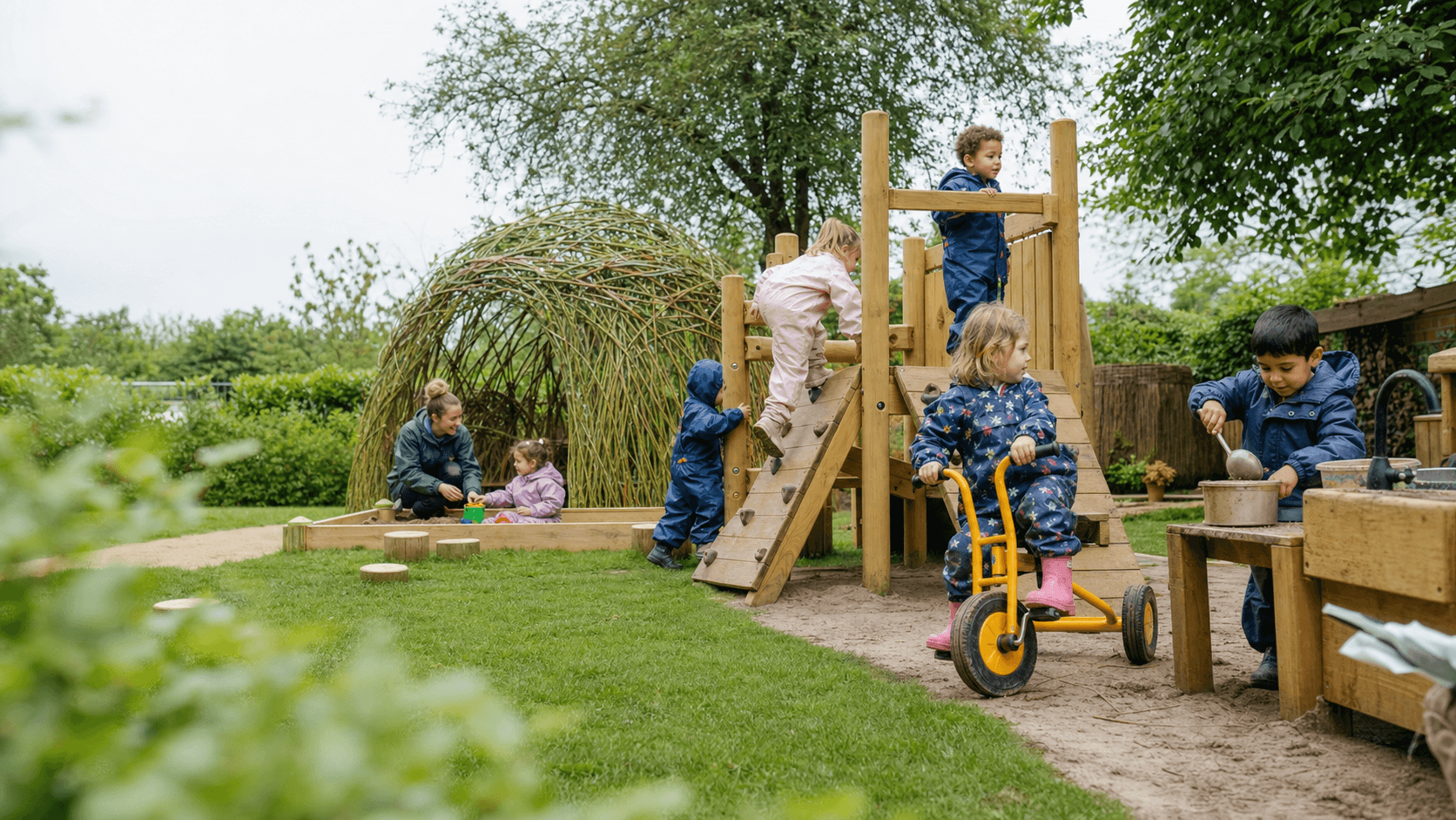 Children enjoying supervised play in a landscaped nursery garden